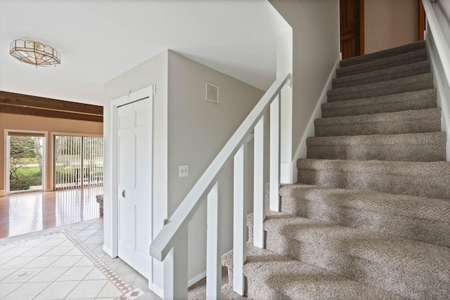 stairway featuring tile patterned floors