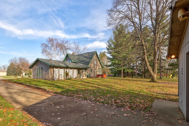 view of side of property with a lawn