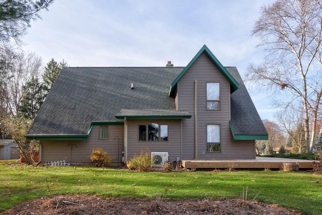 rear view of property featuring a lawn, a wooden deck, and ac unit