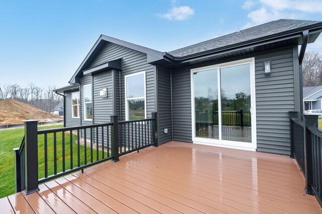 wooden terrace featuring a lawn