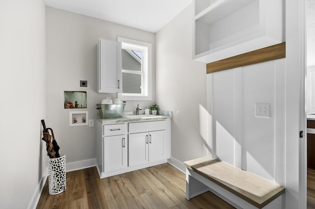 bathroom with vanity, baseboards, and wood finished floors