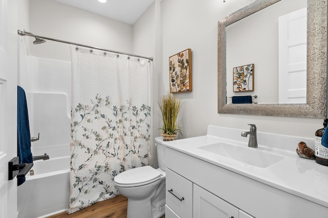 bathroom featuring toilet, wood finished floors, vanity, and shower / bathtub combination with curtain