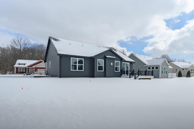 snow covered property with a deck