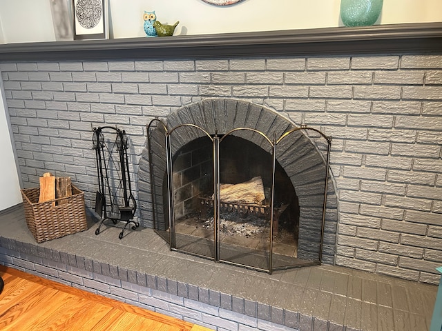 room details with hardwood / wood-style floors and a fireplace