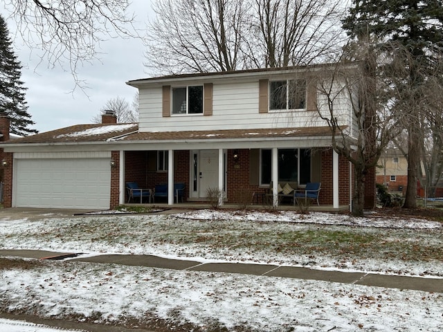 view of front property featuring covered porch and a garage