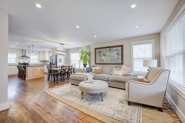 living room with dark wood-type flooring and a notable chandelier