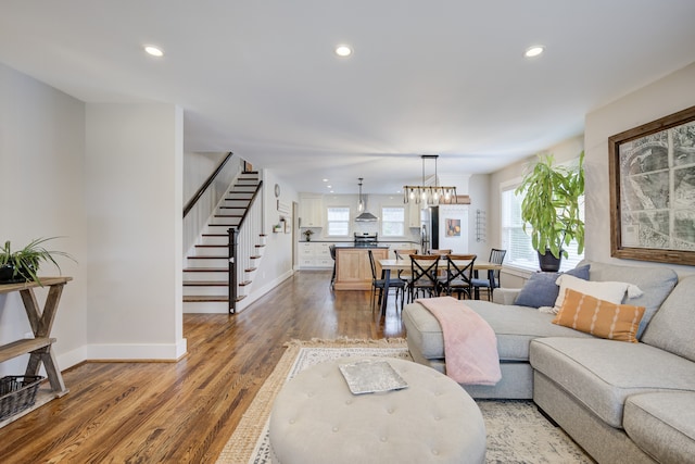 living room featuring an inviting chandelier and hardwood / wood-style flooring