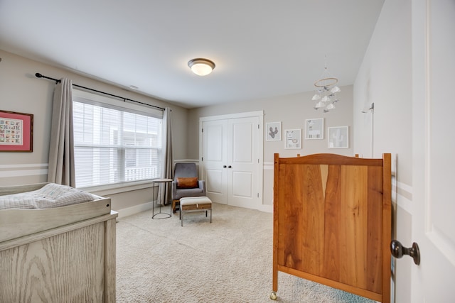 bedroom with a closet and light colored carpet