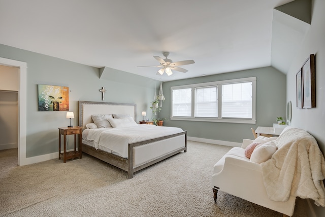 bedroom featuring a spacious closet, ceiling fan, lofted ceiling, light carpet, and a closet