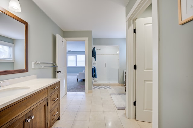 bathroom featuring vanity, tile patterned floors, and a shower with shower door