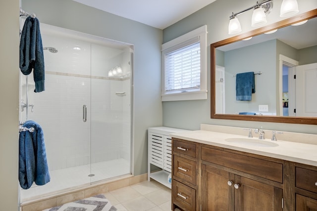 bathroom featuring tile patterned floors, vanity, and a shower with door