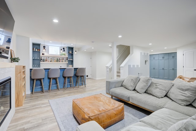 living room featuring light wood-type flooring and bar