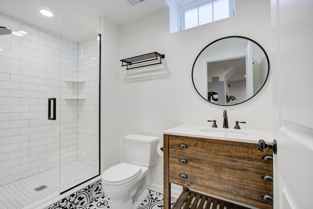 bathroom with tile patterned flooring, vanity, toilet, and a shower with shower door