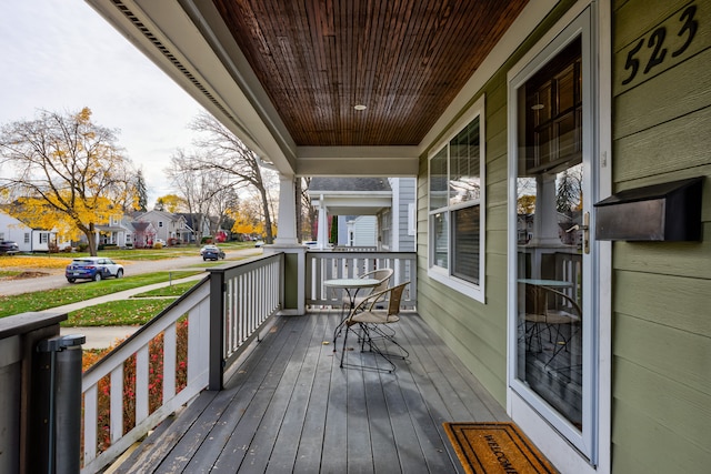 wooden terrace with a porch