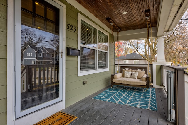 wooden terrace featuring covered porch