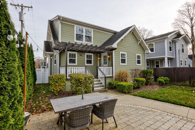 back of house with a pergola and a patio area