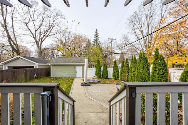 view of yard featuring an outdoor structure and a patio area