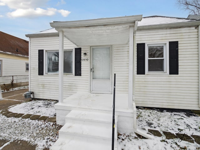 view of snow covered property entrance