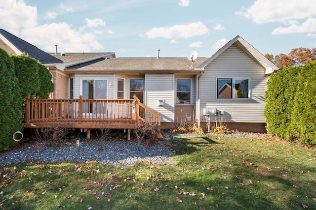 rear view of property featuring a yard and a wooden deck