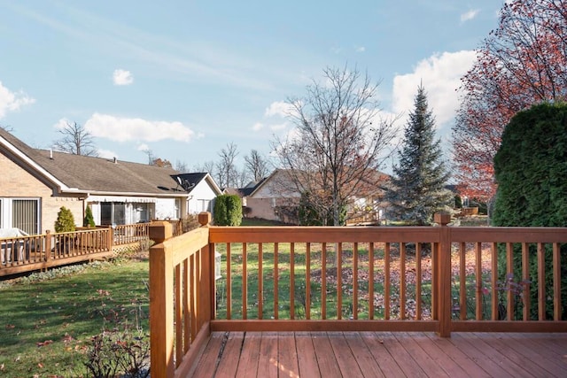 wooden deck featuring a yard