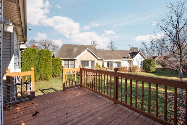 wooden deck featuring a yard