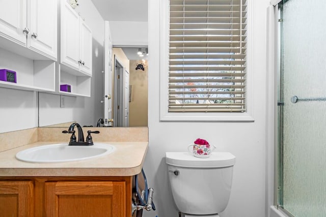 bathroom with vanity, toilet, and walk in shower