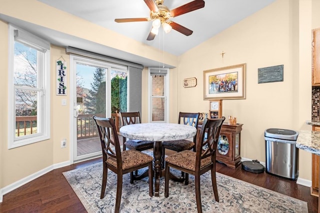 dining room featuring ceiling fan, plenty of natural light, dark wood-type flooring, and lofted ceiling