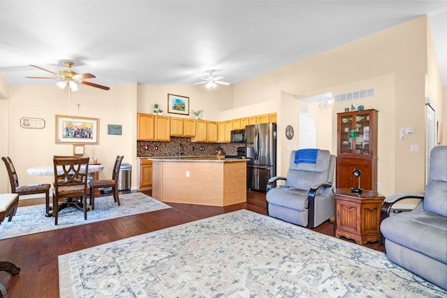 living room featuring ceiling fan and dark hardwood / wood-style flooring