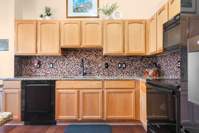 kitchen with dark wood-type flooring, sink, black appliances, and light brown cabinets