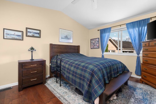 bedroom with ceiling fan, dark wood-type flooring, and lofted ceiling