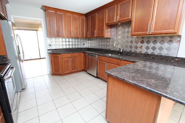 kitchen with tasteful backsplash, stainless steel dishwasher, sink, light tile patterned floors, and dark stone countertops