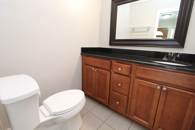 bathroom with tile patterned flooring, vanity, and toilet