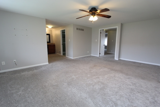 spare room with light carpet and ceiling fan