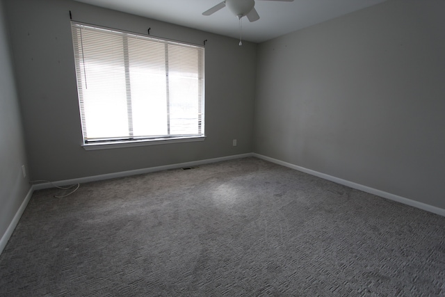 carpeted spare room featuring ceiling fan