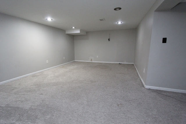 unfurnished room featuring light colored carpet