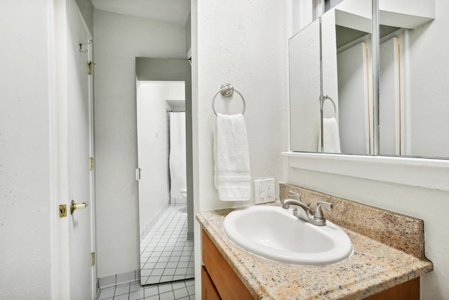 bathroom featuring tile patterned flooring and vanity