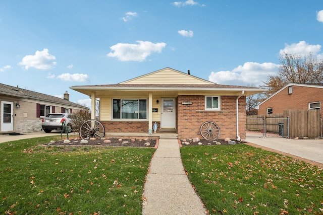 bungalow with covered porch and a front lawn