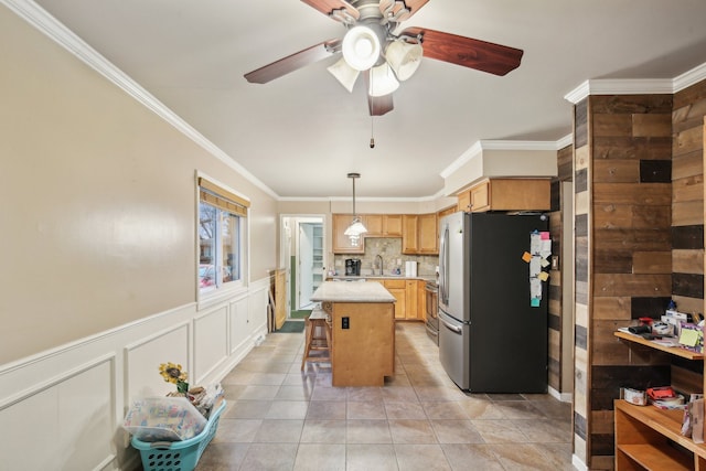 kitchen with stainless steel appliances, backsplash, crown molding, a breakfast bar, and a kitchen island