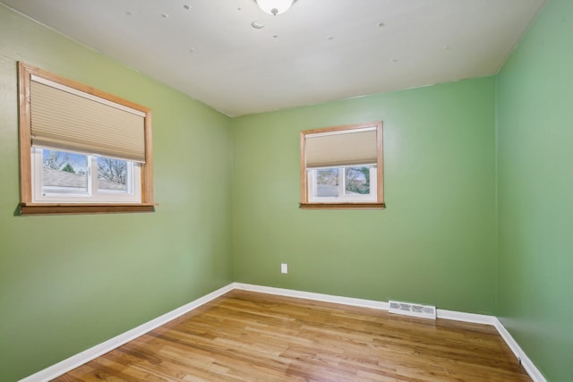 empty room with light hardwood / wood-style flooring