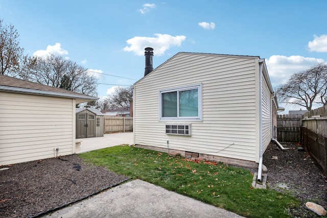 view of property exterior featuring a patio area, a yard, and a shed