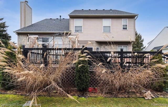 rear view of house with a wooden deck