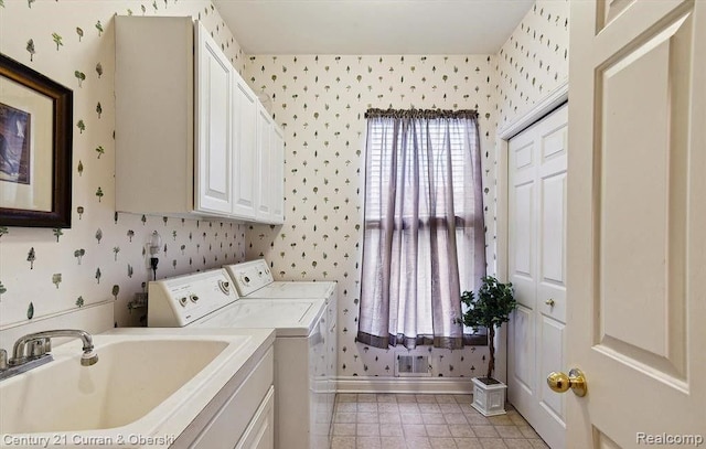 washroom featuring washer and dryer, cabinets, and sink