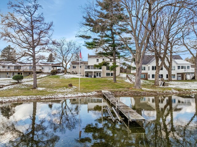 dock area with a yard and a water view