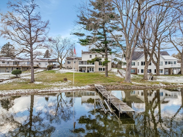 dock area featuring a residential view, a water view, and a yard