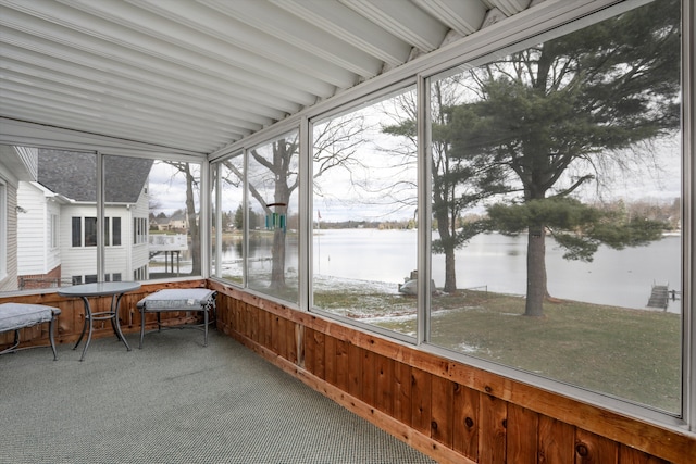 unfurnished sunroom with a water view and a wealth of natural light