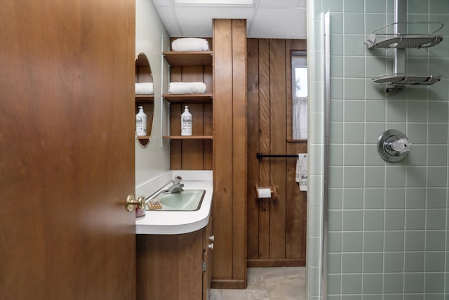 bathroom with vanity and tiled shower