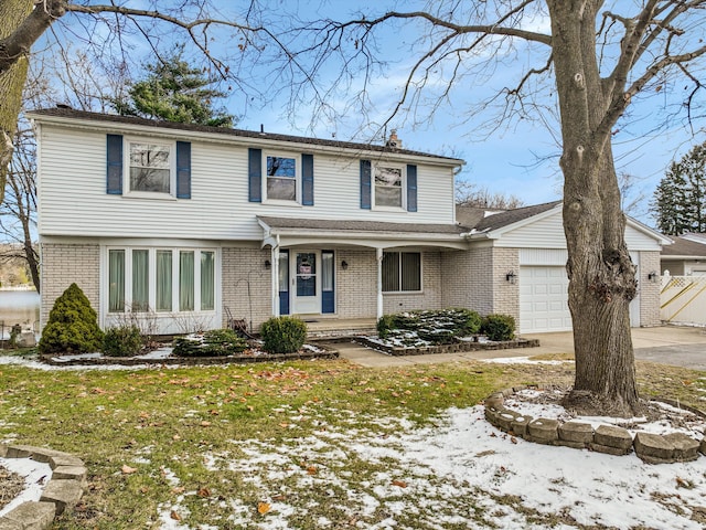 view of front of home featuring brick siding, a chimney, a lawn, an attached garage, and driveway