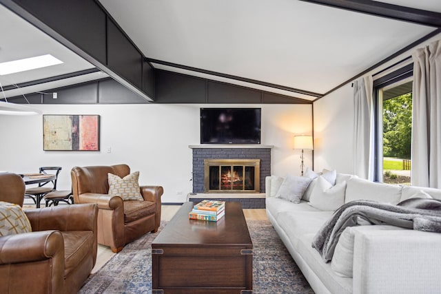 living room featuring hardwood / wood-style floors, lofted ceiling, and a fireplace