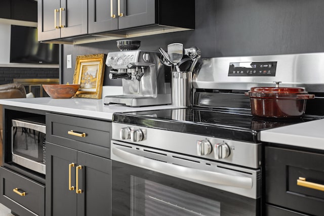 kitchen featuring backsplash, gray cabinetry, and appliances with stainless steel finishes