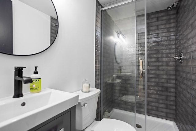 bathroom with vanity, toilet, and a shower with shower door